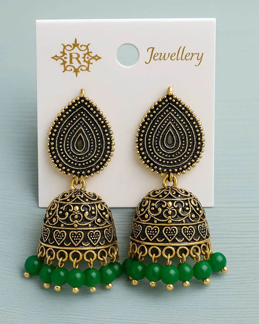 Antique gold jhumka earrings with intricate detailing