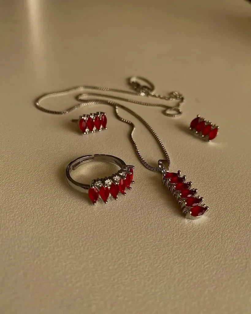 Red accent stainless steel necklace, ring, and earrings