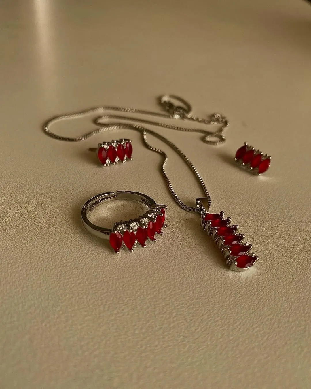 Red accent stainless steel necklace, ring, and earrings